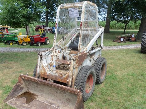 operating old skid steer|excavating with a skid steer.